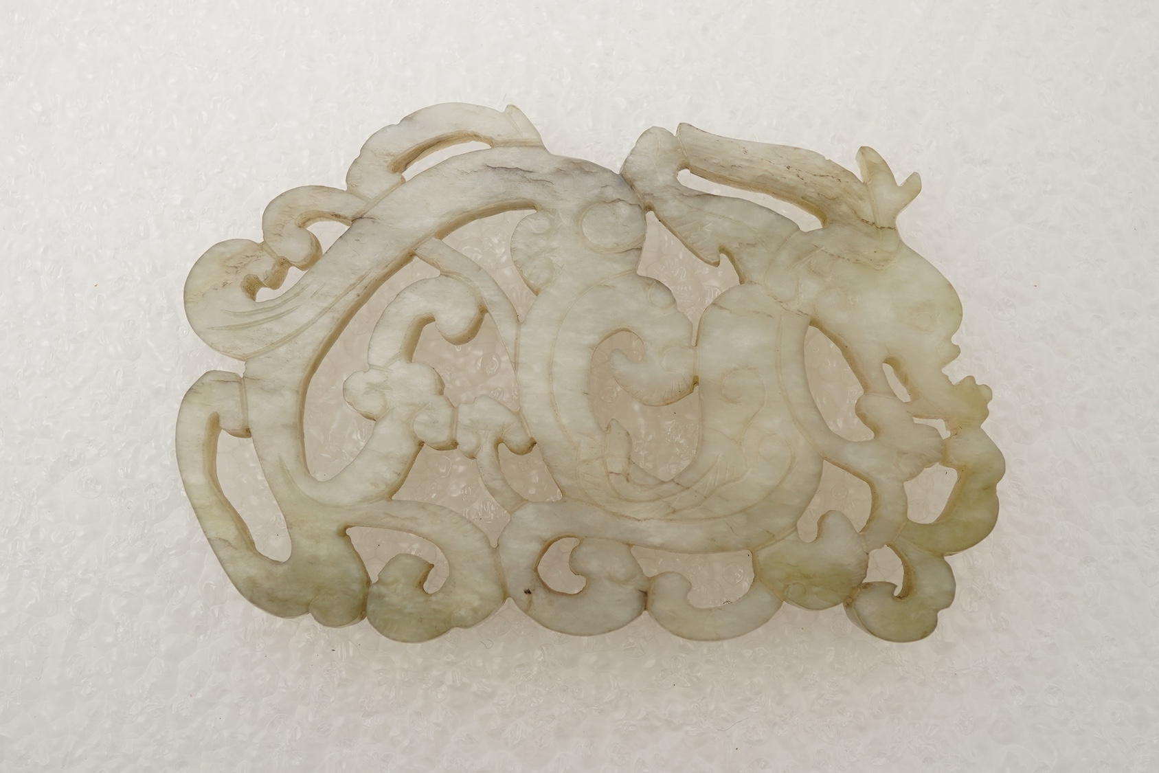 A Chinese white and grey mottled jade ‘chilong’ plaque, Ming dynasty